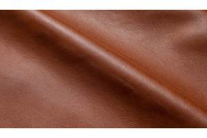 Close-up of genuine leather showing natural patina, rich tones, and aged texture developed over time