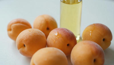 Fresh apricots and apricot oil showing natural skin benefits for glow, hydration, and anti-aging