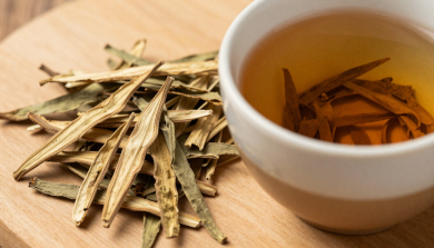 Hunza Gymnema Tea leaves and brewed herbal tea in a cup